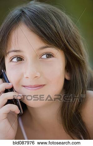 Hispanic girl talking on cell phone View Large Photo Image Stock Photograph - Hispanic girl talking on cell phone. Fotosearch