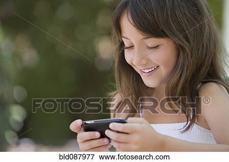 Hispanic girl text messaging on cell phone View Large Photo Image Stock Photo - Hispanic girl text messaging on cell phone. Fotosearch