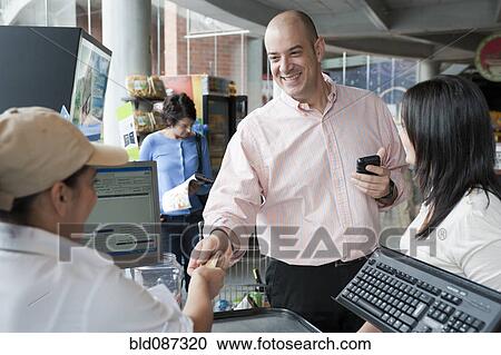 Hispanic man paying with credit card in store View Large Photo Image Stock Image - Hispanic man paying with credit card in store. Fotosearch