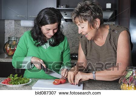 Hispanic mother and daughter preparing salad View Large Photo Image Stock Photo - Hispanic mother and daughter preparing salad. Fotosearch