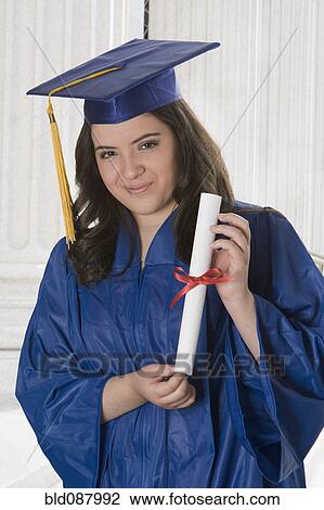 Hispanic teenage girl in graduation cap and gown holding diploma View Large Photo Image Stock Image - Hispanic teenage girl in graduation cap and gown holding diploma. Fotosearch