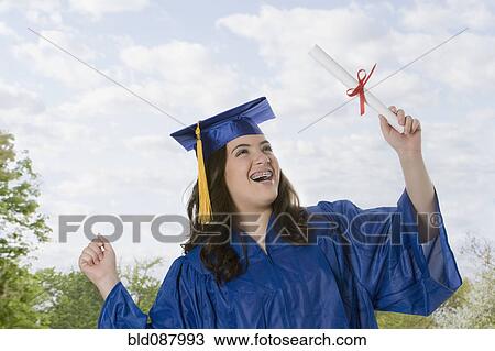Hispanic teenage girl in graduation cap and gown holding diploma View Large Photo Image Stock Image - Hispanic teenage girl in graduation cap and gown holding diploma. Fotosearch