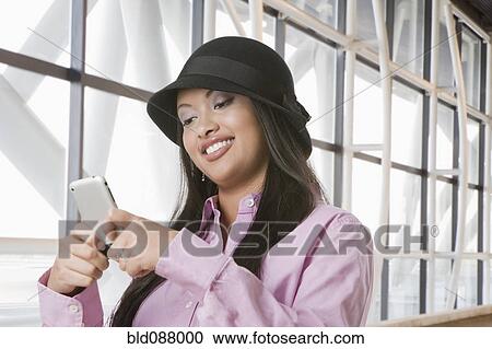 Hispanic teenage girl text messaging on cell phone View Large Photo Image Stock Image - Hispanic teenage girl text messaging on cell phone. Fotosearch