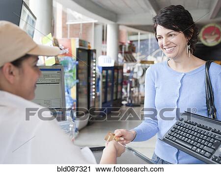 Hispanic woman paying with credit card in store View Large Photo Image Stock Image - Hispanic woman paying with credit card in store. Fotosearch