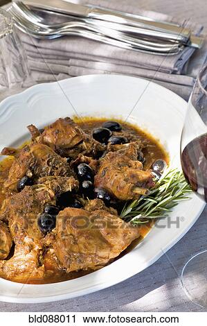Stock Image - Italian coniglio e olive or rabbit and olives. Fotosearch