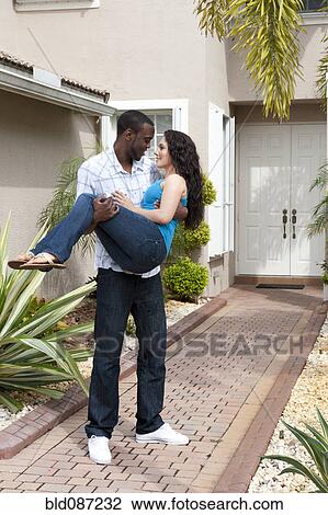Man carrying girlfriend on path to house front door View Large Photo Image Stock Image - Man carrying girlfriend on path to house front door. Fotosearch