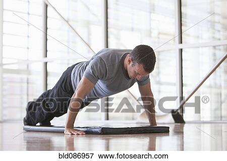 Man doing push-ups in health club View Large Photo Image Stock Photo - Man doing push-ups in health club. Fotosearch