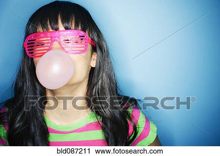Mixed race woman blowing bubble with bubble gum View Large Photo Image Stock Image - Mixed race woman blowing bubble with bubble gum. Fotosearch