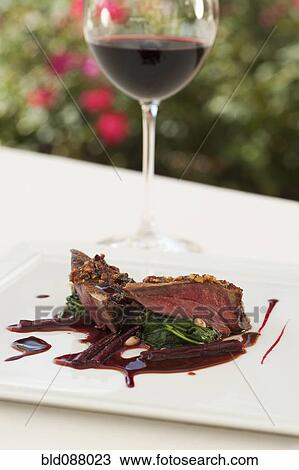 Stock Image - Red wine and pigeon entree. Fotosearch