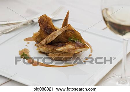 Stock Image - Roast chicken on plate with demi-glaze. Fotosearch