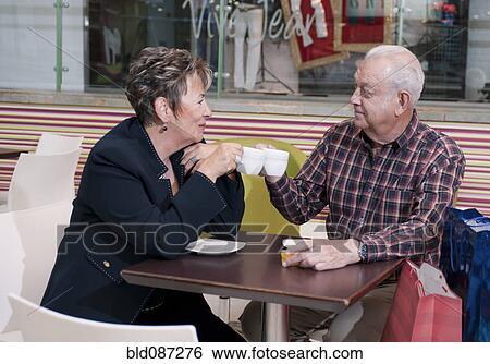 Senior Hispanic couple drinking coffee in cafe View Large Photo Image Stock Photograph - Senior Hispanic couple drinking coffee in cafe. Fotosearch
