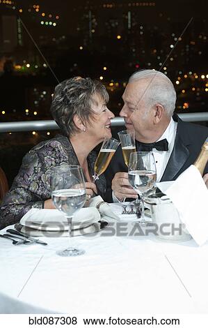 Senior Hispanic couple toasting with Champagne in restaurant View Large Photo Image Stock Photo - Senior Hispanic couple toasting with Champagne in restaurant. Fotosearch