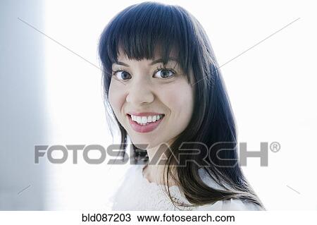 Stock Image - Smiling mixed race woman. Fotosearch