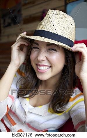 Smiling mixed race woman wearing hat View Large Photo Image Stock Photograph - Smiling mixed race woman wearing hat. Fotosearch