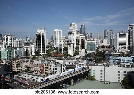 A mass transit train passes through Bangkok downtown business district View Large Photo Image Stock Photograph - A mass transit train passes through Bangkok downtown business district. Fotosearch