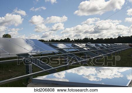 Stock Photo - A row of solar panels installed in a rural situation. Fotosearch
