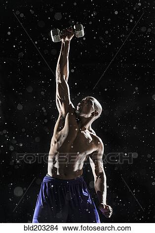 African American athlete lifting weights in rain View Large Photo Image Picture - African American athlete lifting weights in rain. Fotosearch
