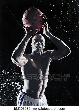 Stock Image - African American basketball player splashing in water. Fotosearch