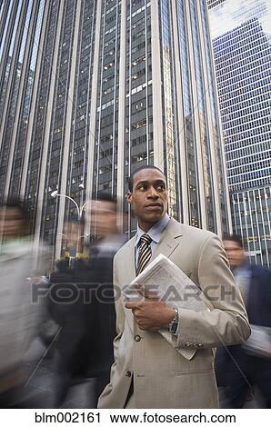African American businessman holding newspaper View Large Photo Image Stock Image - African American businessman holding newspaper. Fotosearch