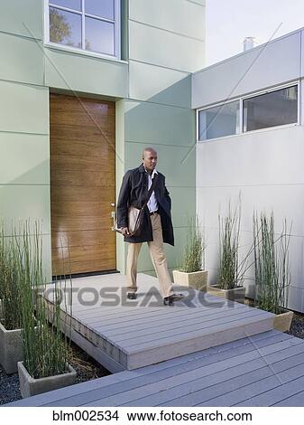 African American businessman leaving house View Large Photo Image Picture - African American businessman leaving house. Fotosearch