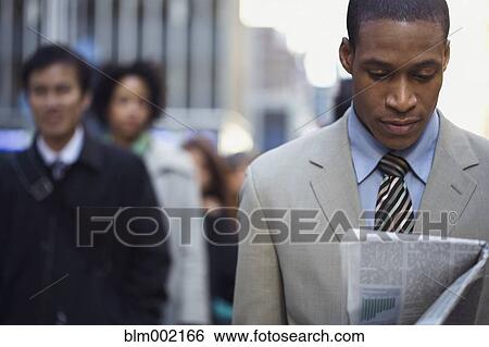 African American businessman reading newspaper View Large Photo Image Stock Photograph - African American businessman reading newspaper. Fotosearch