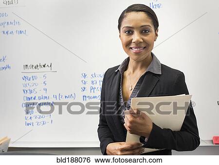 Stock Photograph - African American businesswoman smiling in office. Fotosearch