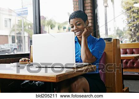 African American businesswoman using laptop in restaurant View Large Photo Image Stock Image - African American businesswoman using laptop in restaurant. Fotosearch