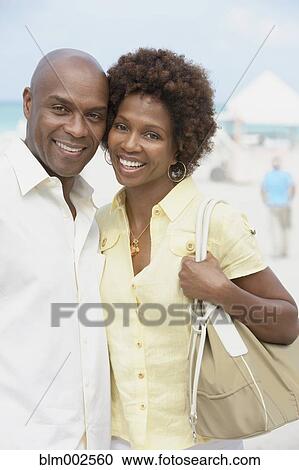 Stock Image - African American couple hugging. Fotosearch