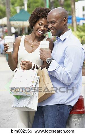 Stock Photography - African American couple with shopping bags. Fotosearch