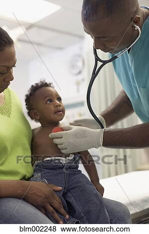 African American doctor examining baby View Large Photo Image Stock Photo - African American doctor examining baby. Fotosearch