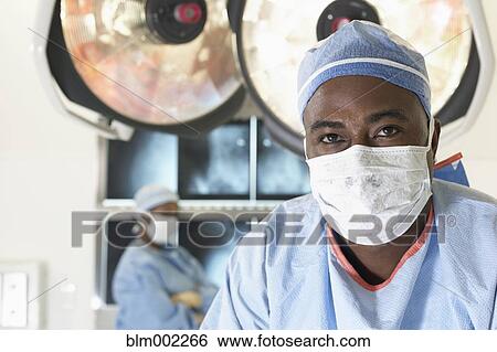 Stock Photograph - African American doctor wearing surgical mask. Fotosearch