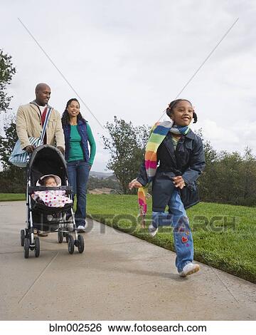 African American family taking walk with stroller View Large Photo Image Stock Photograph - African American family taking walk with stroller. Fotosearch