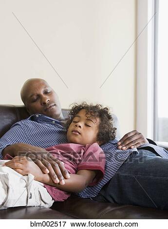 Stock Photo - African American father and son sleeping. Fotosearch