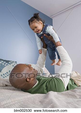 African American father playing with baby View Large Photo Image Stock Image - African American father playing with baby. Fotosearch