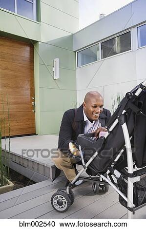 African American father smiling at baby in stroller View Large Photo Image Stock Image - African American father smiling at baby in stroller. Fotosearch