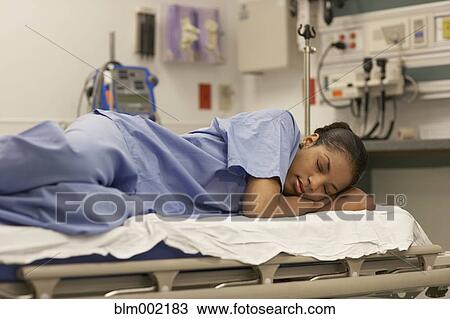 Stock Image - African American female medical professional sleeping. Fotosearch