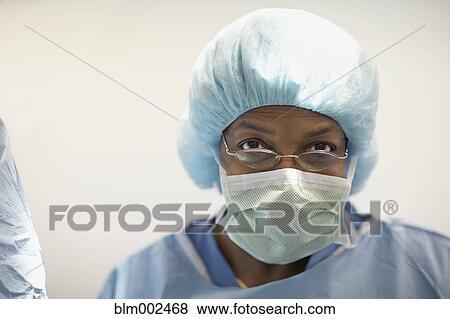 Stock Photo - African American female medical professional wearing surgical mask. Fotosearch