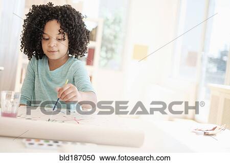 Stock Image - African American girl painting with watercolors. Fotosearch