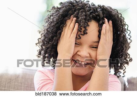 Stock Photo - African American girl tossing her hair. Fotosearch