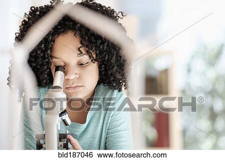 African American girl using microscope in science classroom View Large Photo Image Stock Photograph - African American girl using microscope in science classroom. Fotosearch