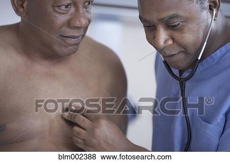 African American male doctor examining patient View Large Photo Image Stock Photo - African American male doctor examining patient. Fotosearch