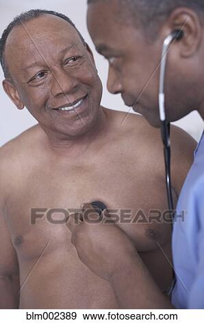 African American male doctor examining patient View Large Photo Image Stock Photo - African American male doctor examining patient. Fotosearch