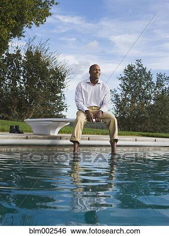 African American man sitting on diving board View Large Photo Image Stock Photograph - African American man sitting on diving board. Fotosearch