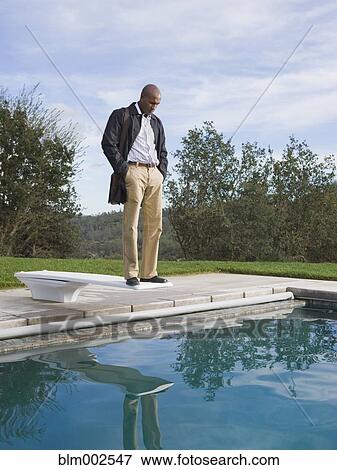 African American man standing on diving board View Large Photo Image Stock Photo - African American man standing on diving board. Fotosearch