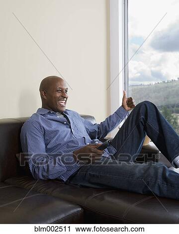 African American man watching television View Large Photo Image Stock Image - African American man watching television. Fotosearch