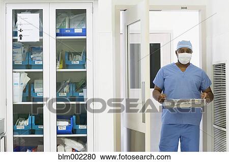 African American medical professional carrying surgical tools View Large Photo Image Stock Image - African American medical professional carrying surgical tools. Fotosearch