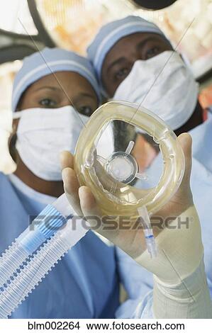 Picture - African American medical professionals with oxygen mask. Fotosearch