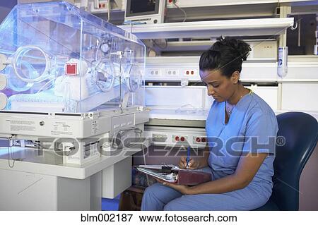 African American nurse writing on chart View Large Photo Image Stock Photo - African American nurse writing on chart. Fotosearch