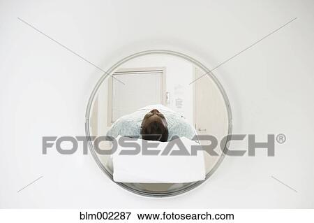 Stock Photo - African American patient on MRI bed. Fotosearch