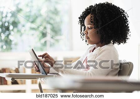 African American student using digital tablet in classroom View Large Photo Image Stock Photography - African American student using digital tablet in classroom. Fotosearch